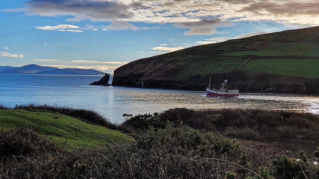 Fishing boat in Dingle Harbour heading out to sea 