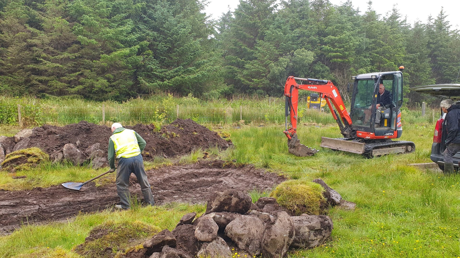 Michael smoothing out the layers of the pond by hand