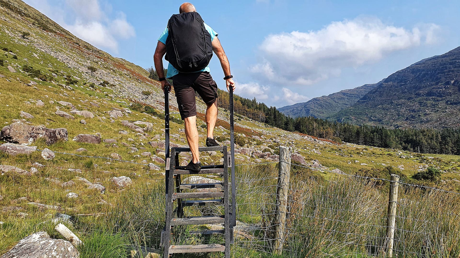 Gerhard climbing over a style in the Black Valley, County Kerry, Ireland