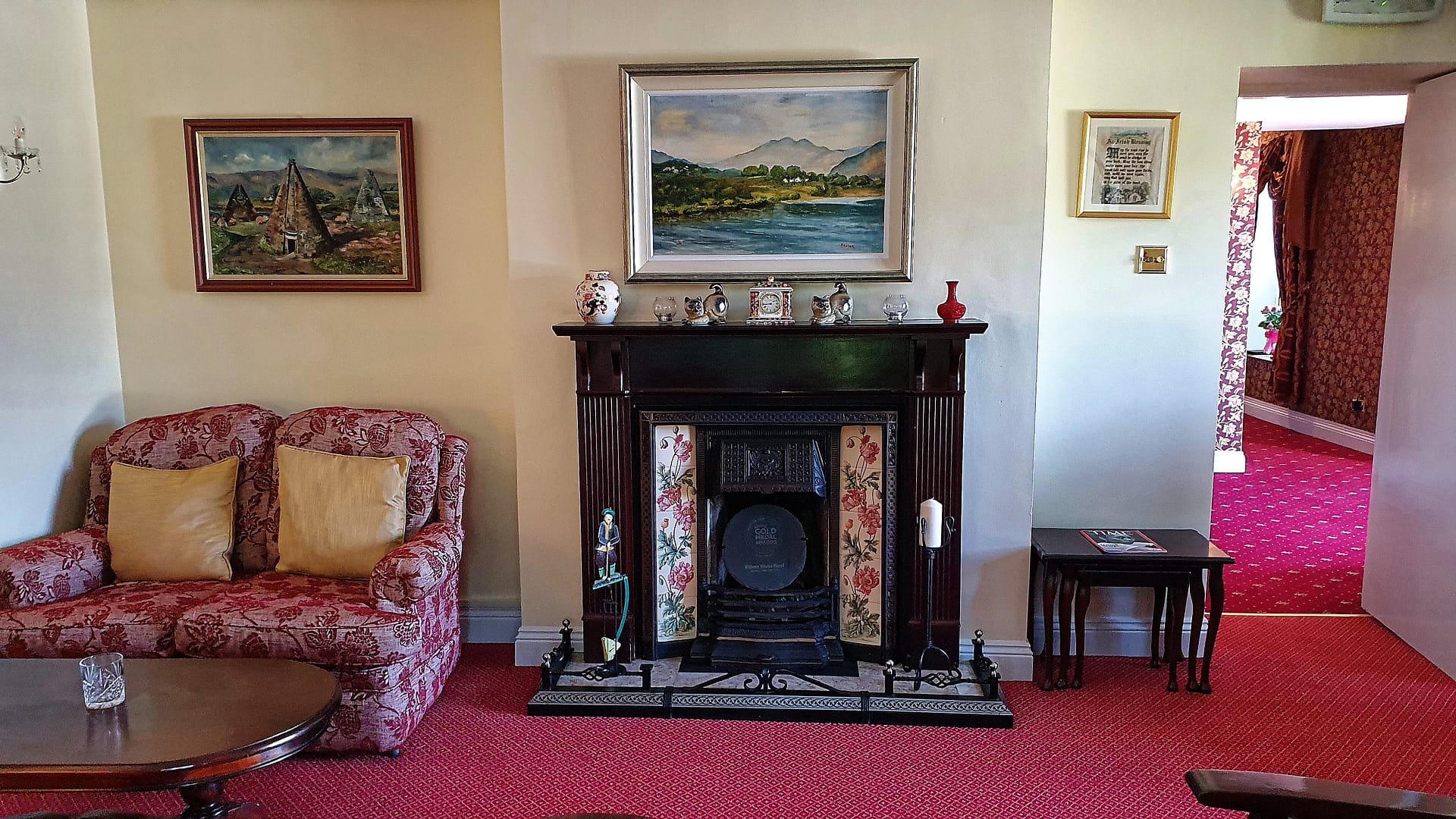 I love the fireplace, with its tiles of roses, in the sitting room.
